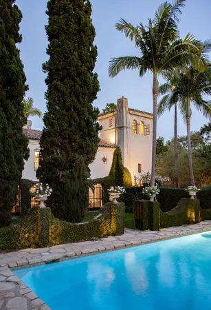 a view of a patio with couches table and chairs and potted plants