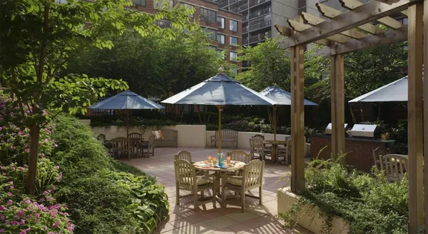 a kitchen with stainless steel appliances dining table and chair