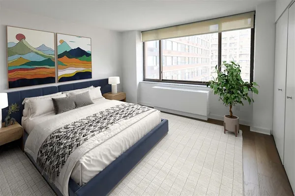 a bedroom with a bed and a painting on the wall