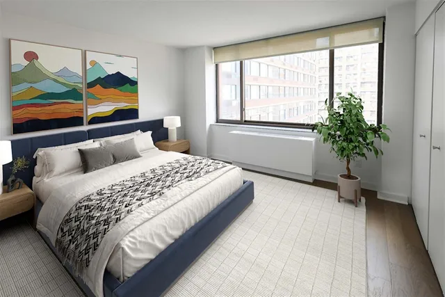 a bedroom with a bed and a painting on the wall