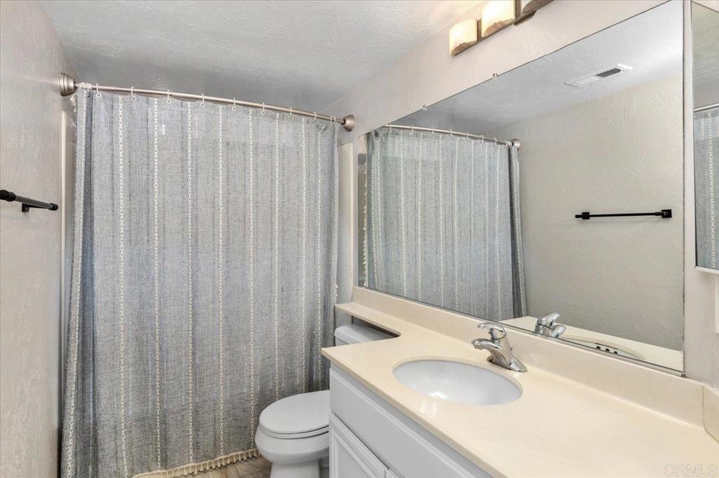 1533 Promontory Ridge Way Vista, CA 92081 - Photo 13 of 26 a bathroom with a sink and a mirror