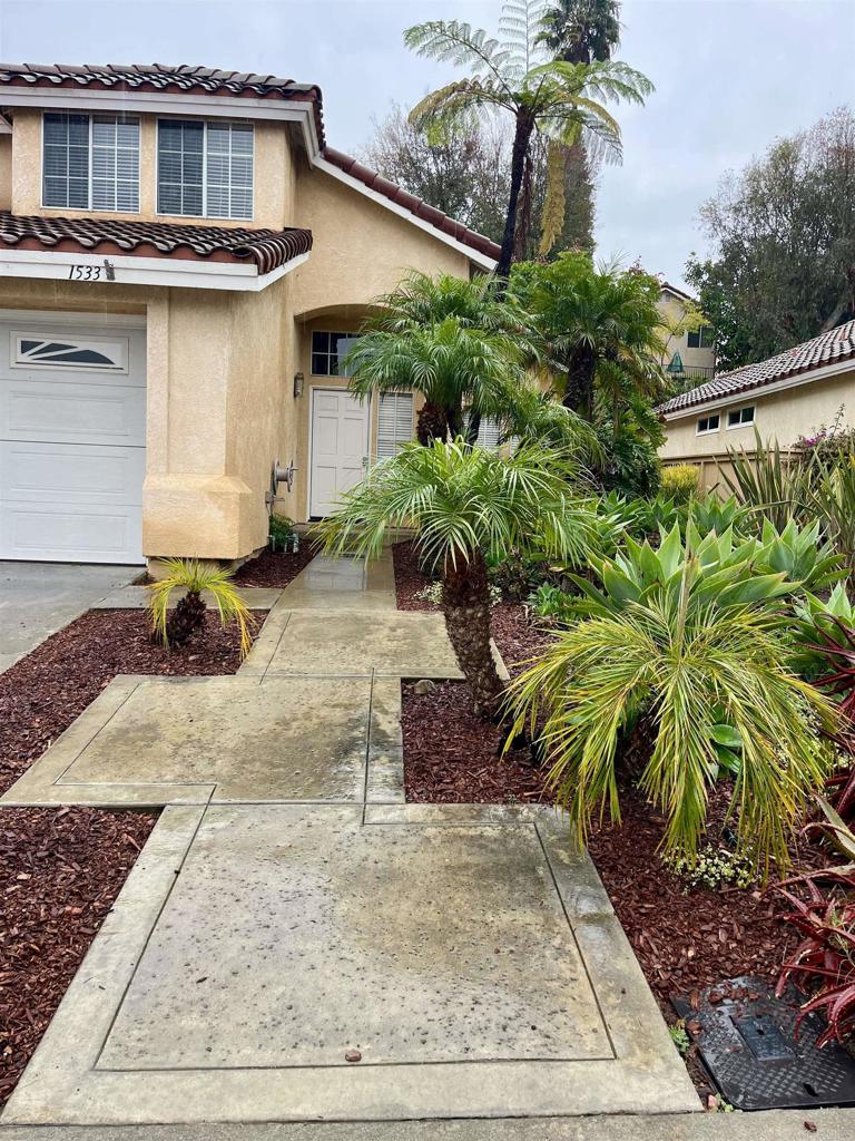 1533 Promontory Ridge Way Vista, CA 92081 - Photo 23 of 26 a front view of a house with garden