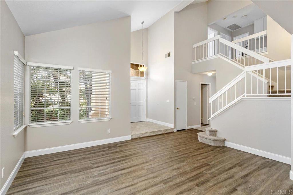 1533 Promontory Ridge Way Vista, CA 92081 - Photo 3 of 26 an empty room with wooden floor and windows