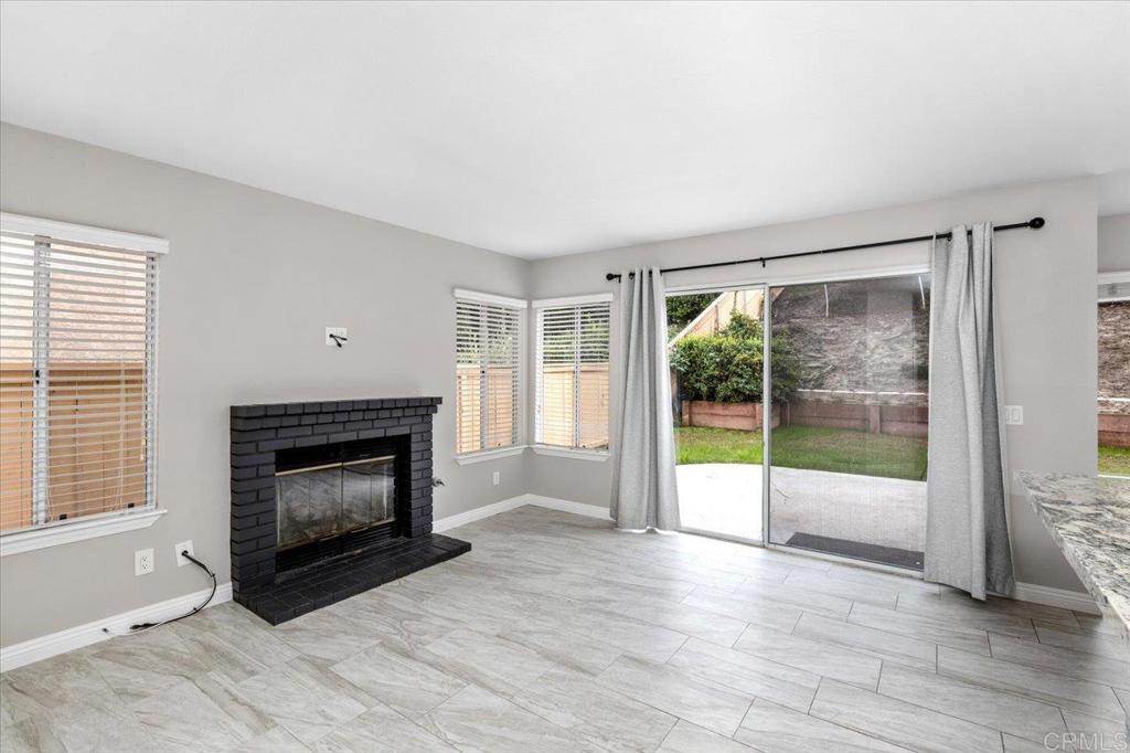 1533 Promontory Ridge Way Vista, CA 92081 - Photo 6 of 26 a view of an empty room with a fireplace and a window
