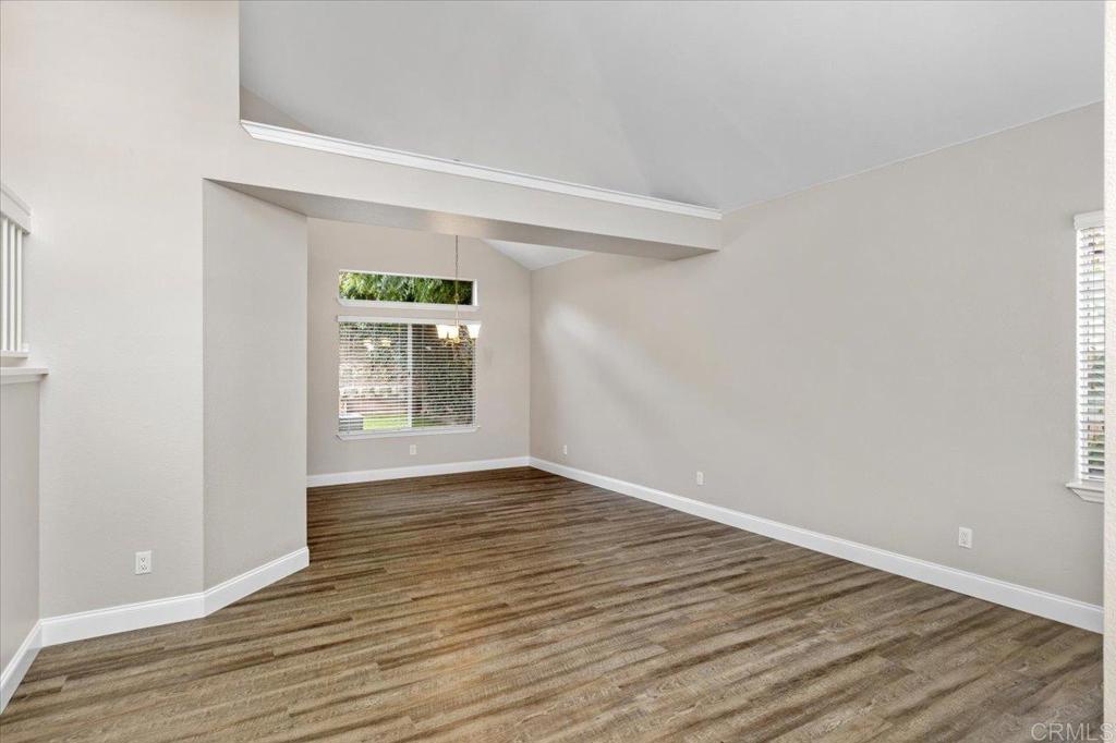 1533 Promontory Ridge Way Vista, CA 92081 - Photo 8 of 26 a view of an empty room with wooden floor and a window