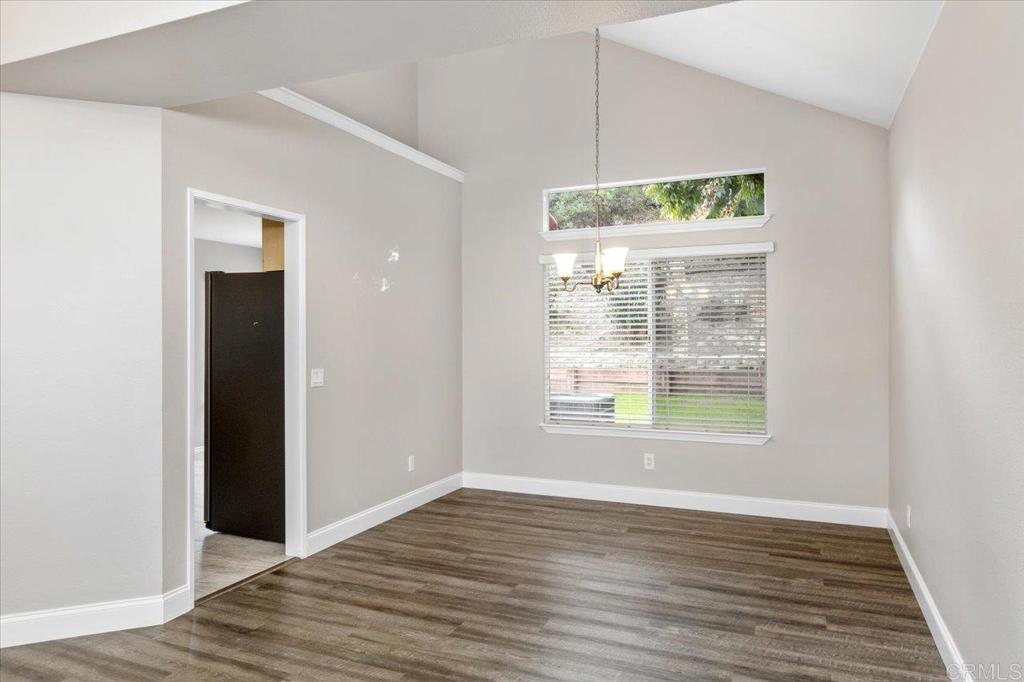 1533 Promontory Ridge Way Vista, CA 92081 - Photo 9 of 26 an empty room with wooden floor and a window