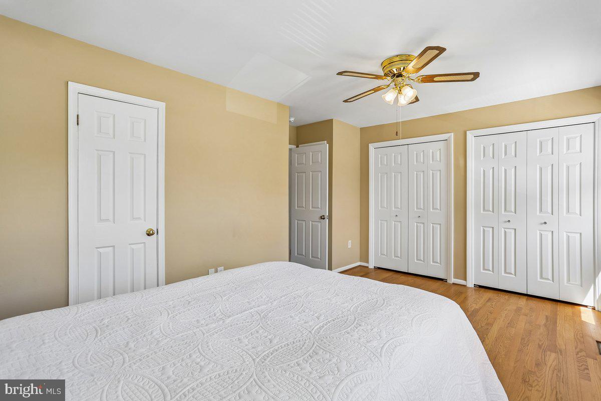 76 Timber Rock Road Gaithersburg, MD 20878 - Photo 22 of 51 a bedroom with a bed and a chandelier