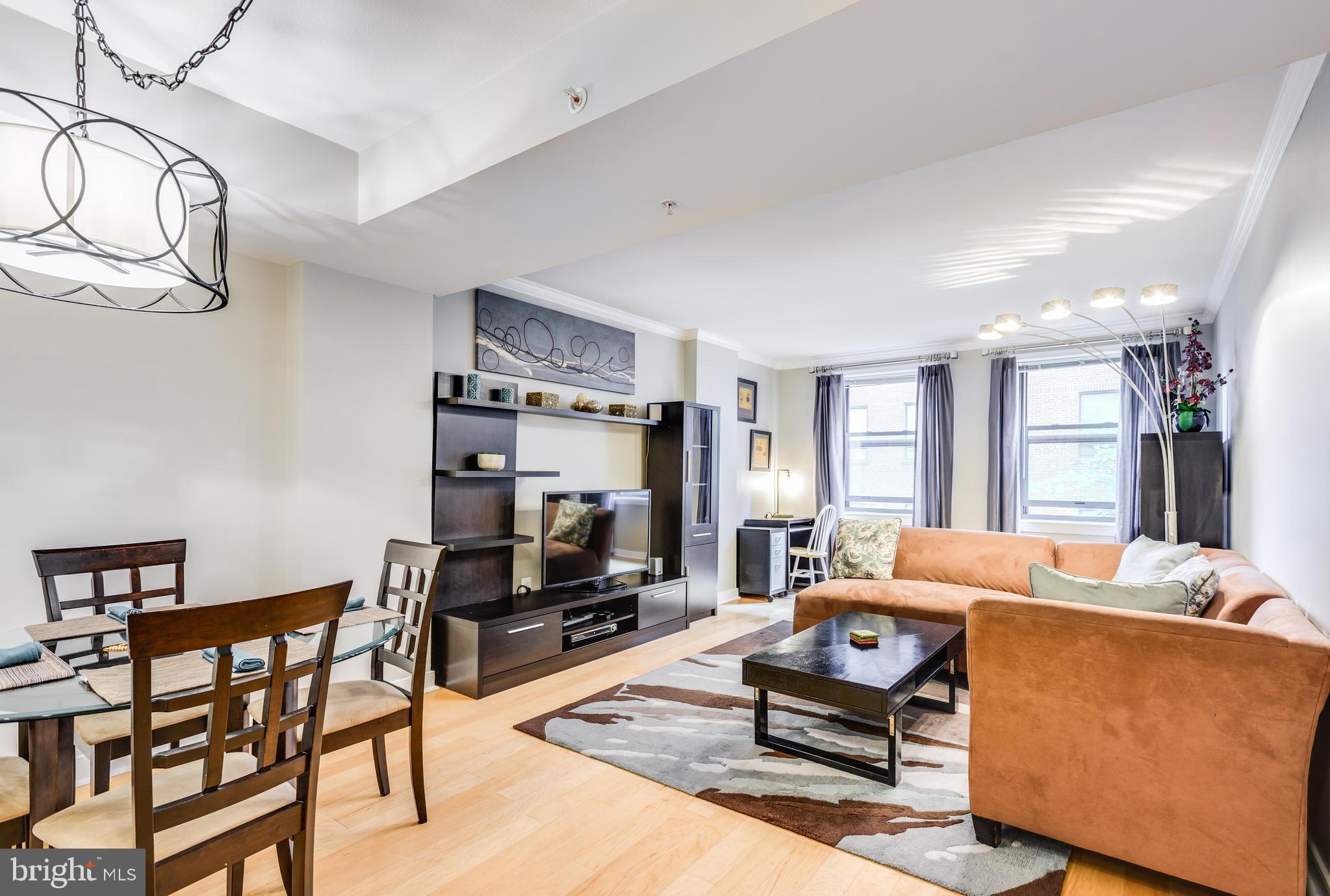 616 E Street Northwest, Unit 446 Washington, DC 20004 - Photo 11 of 66 a living room with furniture a flat screen tv and a table