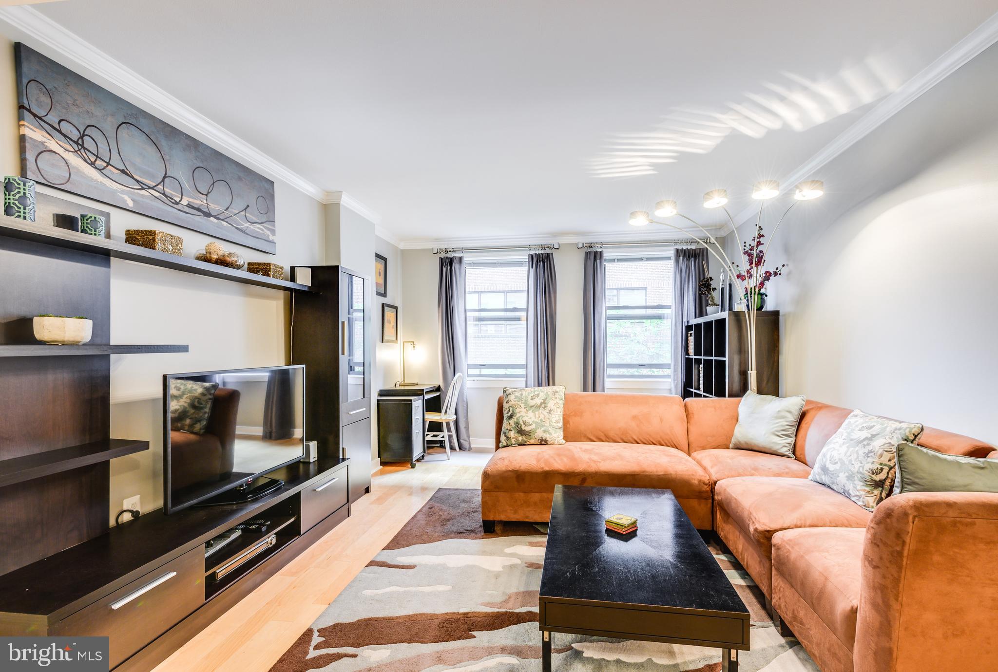 616 E Street Northwest, Unit 446 Washington, DC 20004 - Photo 12 of 66 a bedroom with furniture and a flat screen tv