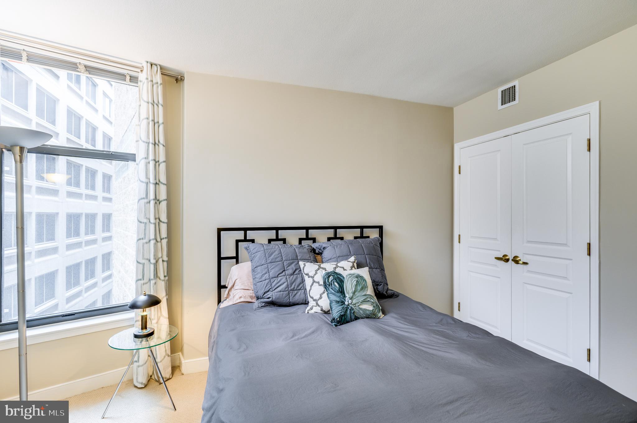 616 E Street Northwest, Unit 446 Washington, DC 20004 - Photo 21 of 66 a spacious bedroom with a bed and a window
