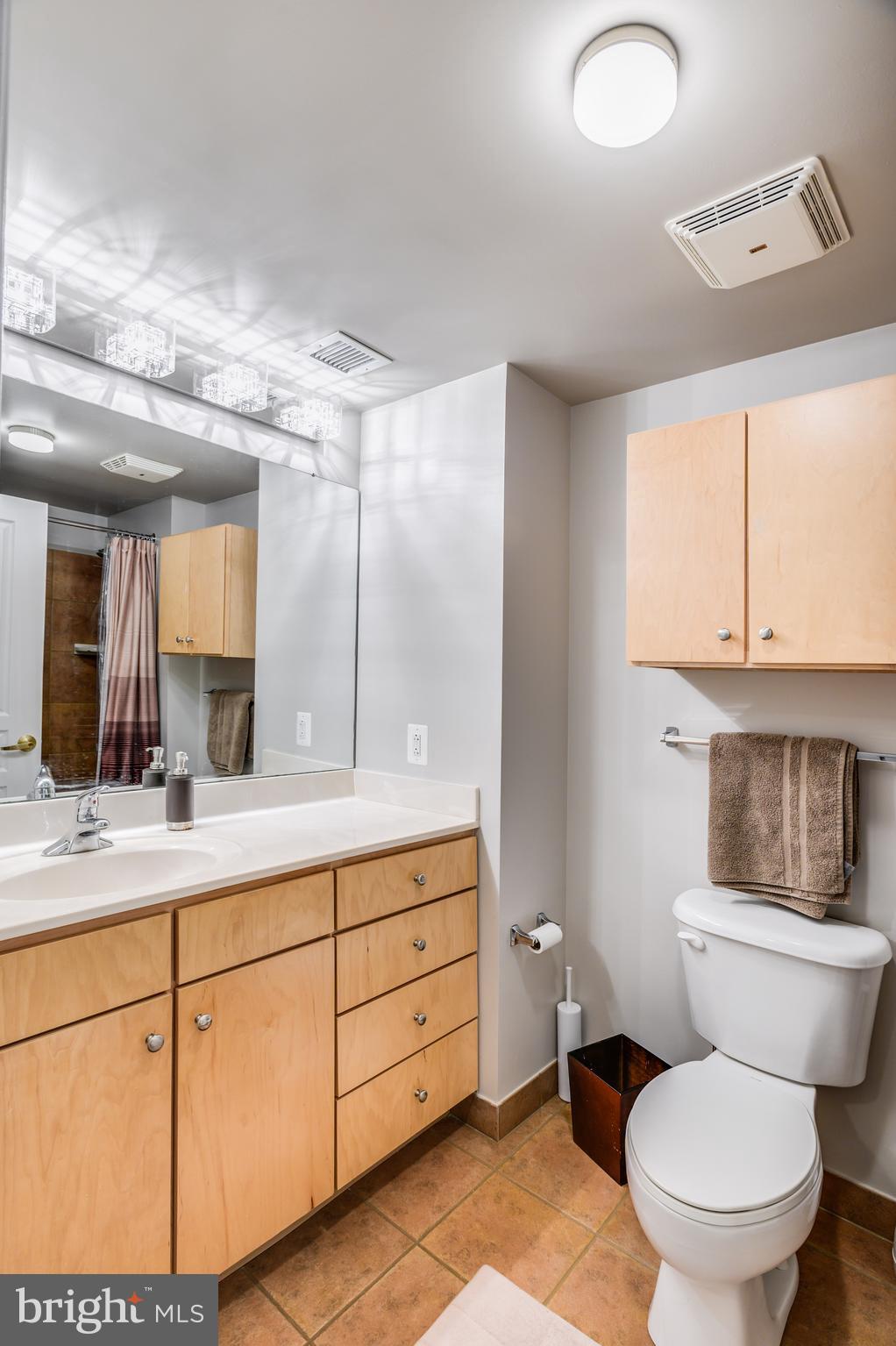 616 E Street Northwest, Unit 446 Washington, DC 20004 - Photo 23 of 66 a bathroom with a toilet a sink and mirror