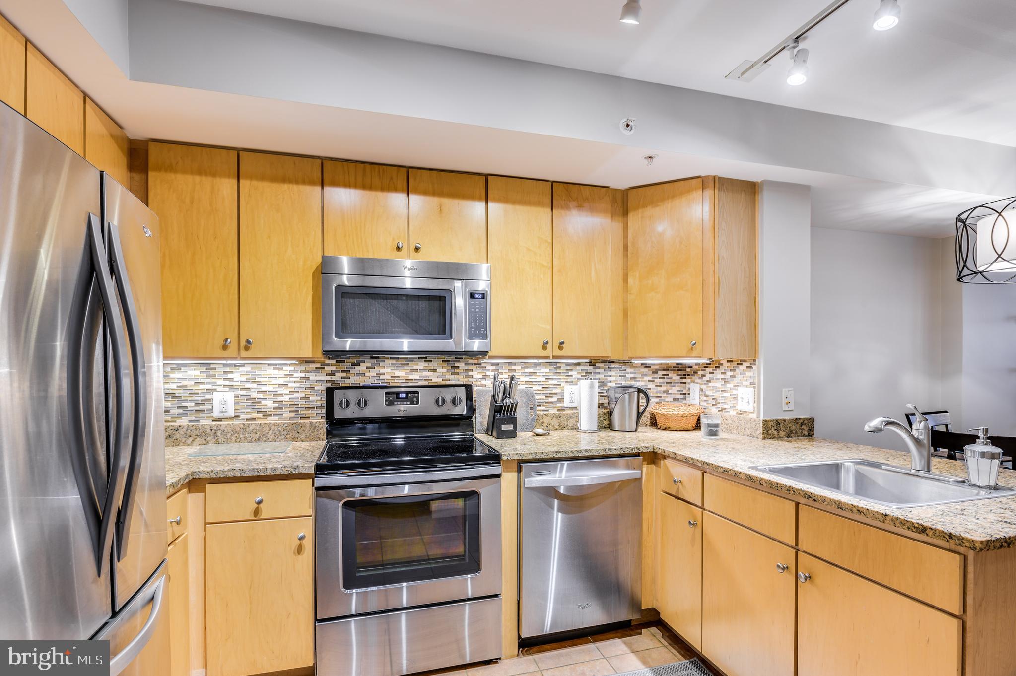 616 E Street Northwest, Unit 446 Washington, DC 20004 - Photo 4 of 66 a kitchen with a stove a sink and a refrigerator