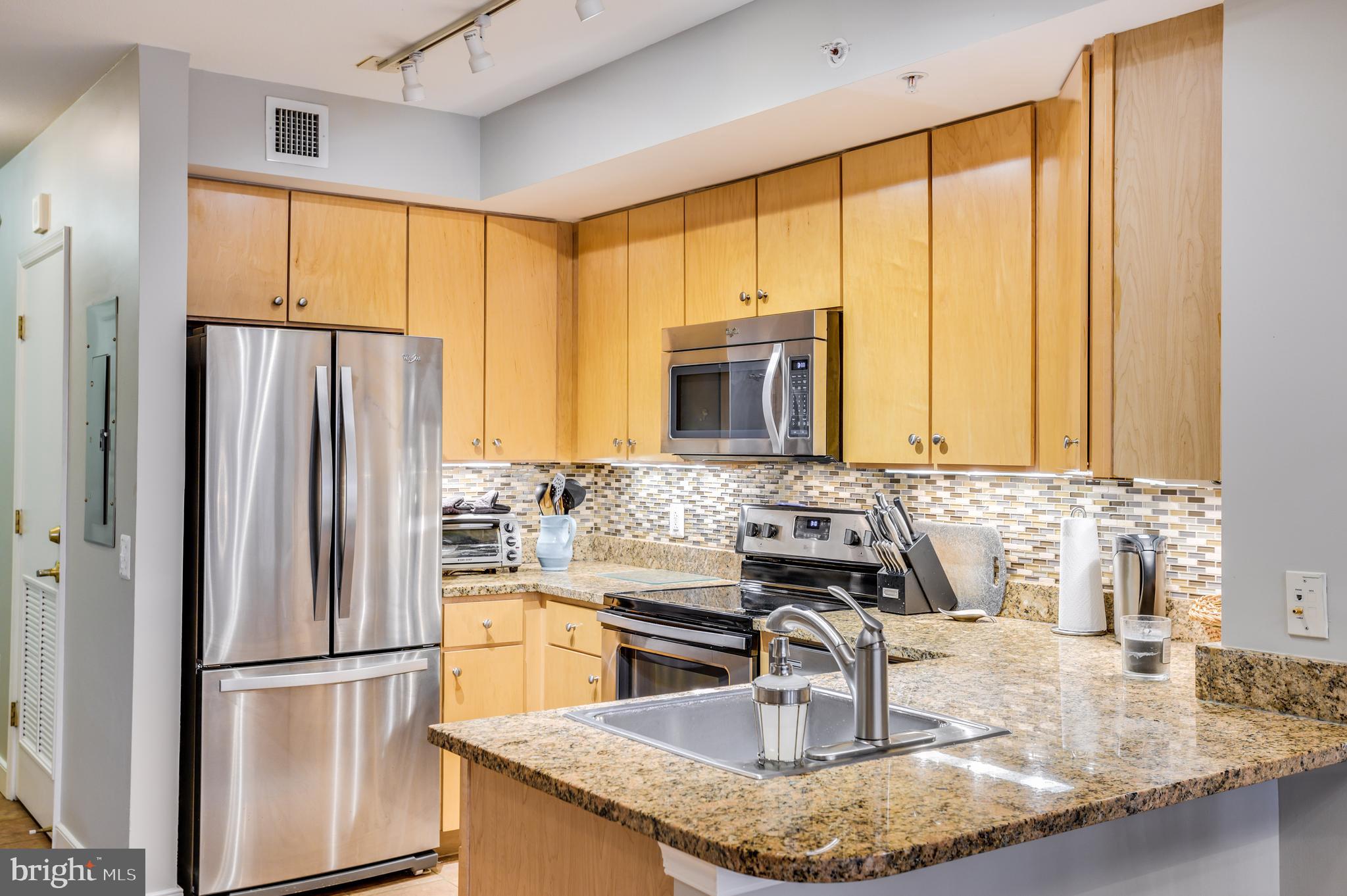 616 E Street Northwest, Unit 446 Washington, DC 20004 - Photo 9 of 66 a kitchen with stainless steel appliances granite countertop a refrigerator a sink and a stove