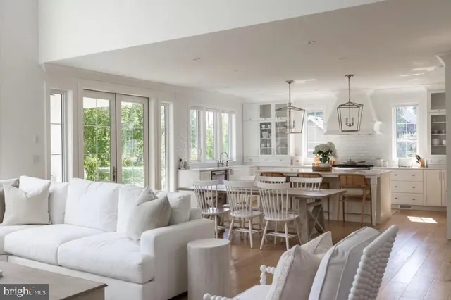 a living room with furniture kitchen and a large window
