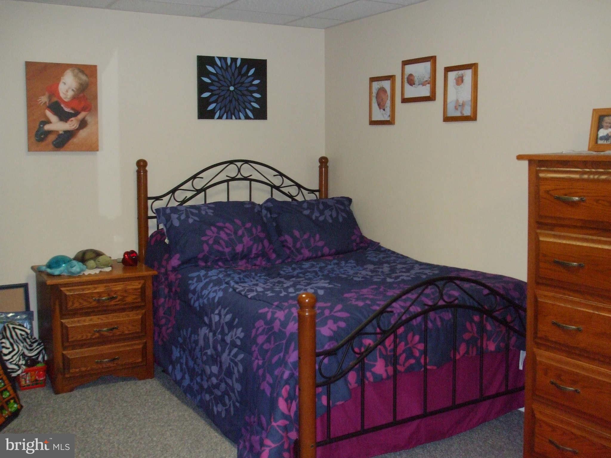 595 Ridgewood Road Bel Air, MD 21014 - Photo 26 of 26 a bed sitting in a bedroom next to a cabinet