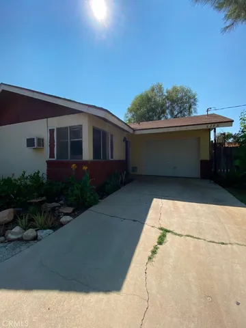 a front view of a house with plants