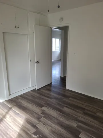 a view of an empty room and wooden floor