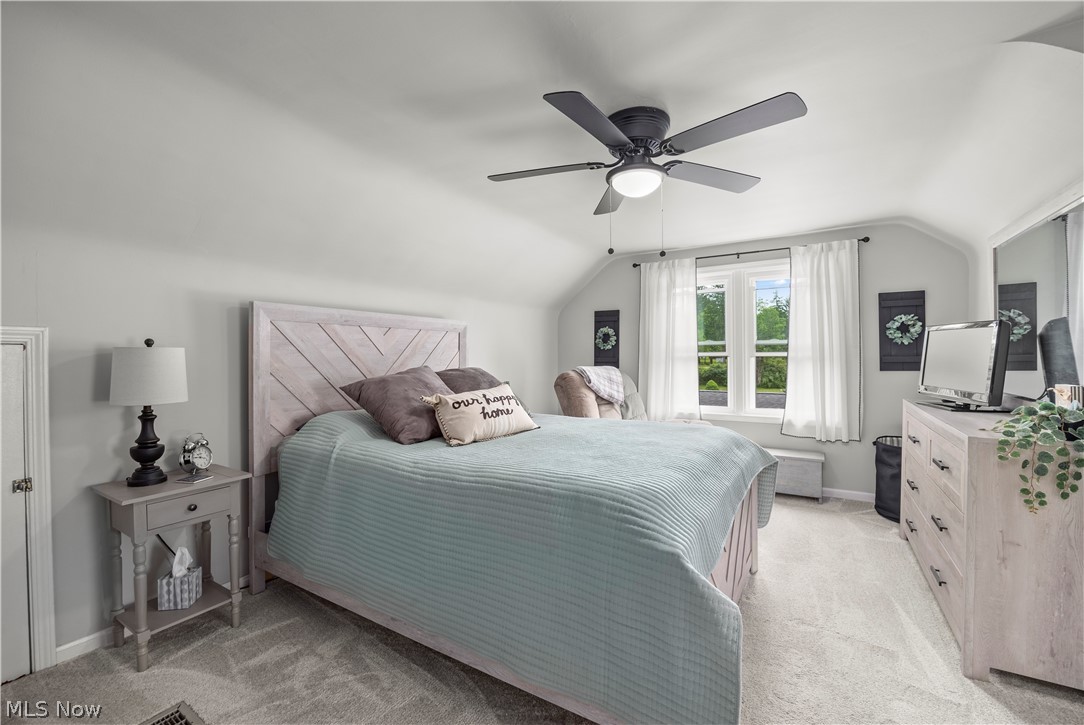 11492 Ridge Road North Royalton, OH 44133 - Photo 22 of 32 Carpeted bedroom featuring a window with white curtains, a ceiling fan with integrated lighting