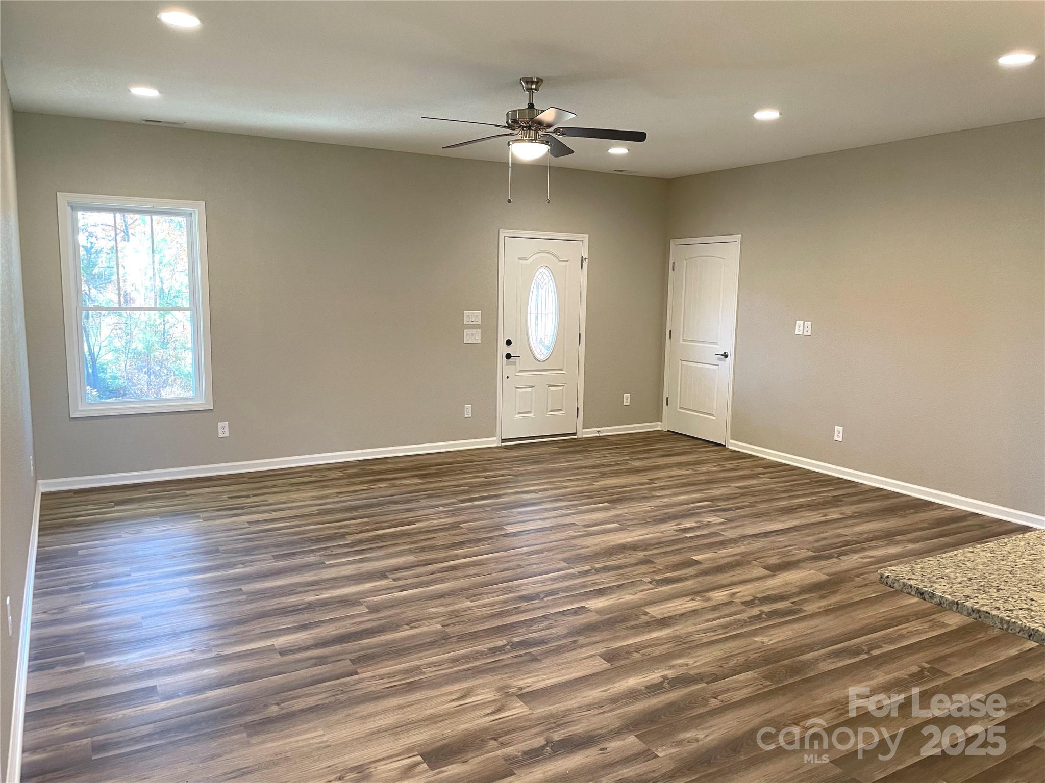 1358 Scenic Lane Granite Falls, NC 28630 - Photo 5 of 5 an empty room with wooden floor and windows