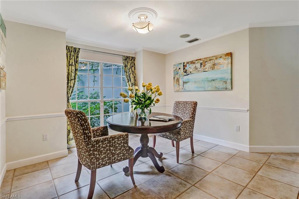 6917 Mill Run Road Naples, FL 34109 - Photo 13 of 29 a dining room with furniture and wooden floor