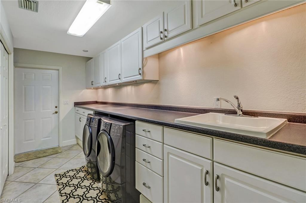 6917 Mill Run Road Naples, FL 34109 - Photo 16 of 29 a utility room with cabinets