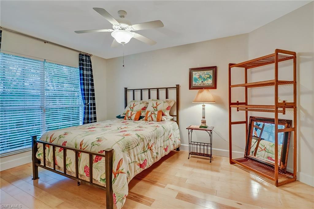6917 Mill Run Road Naples, FL 34109 - Photo 17 of 29 a bed sitting in a bedroom next to a window