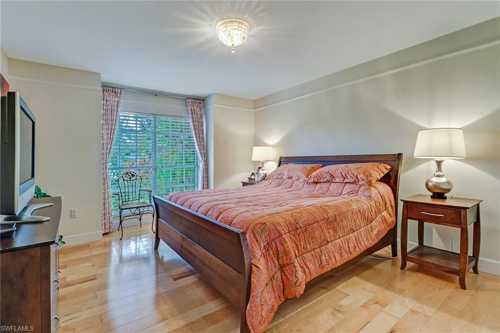 6917 Mill Run Road Naples, FL 34109 - Photo 20 of 29 a bedroom with a bed and a flat screen tv