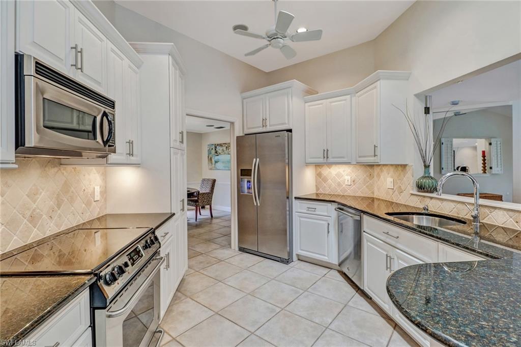 6917 Mill Run Road Naples, FL 34109 - Photo 2 of 29 a kitchen with stainless steel appliances granite countertop a refrigerator a stove and a sink