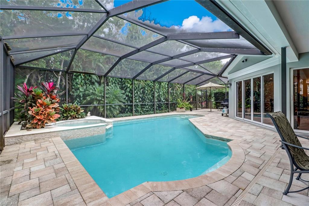 6917 Mill Run Road Naples, FL 34109 - Photo 28 of 29 a view of a swimming pool with a porch