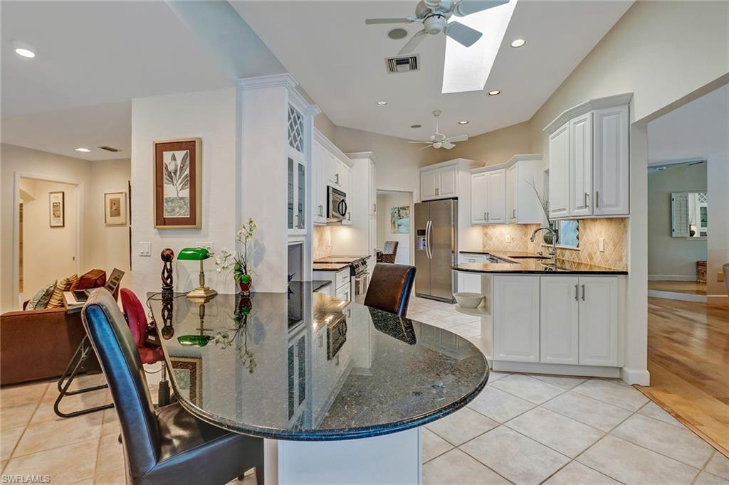 6917 Mill Run Road Naples, FL 34109 - Photo 4 of 29 a view of kitchen with dining table and chairs