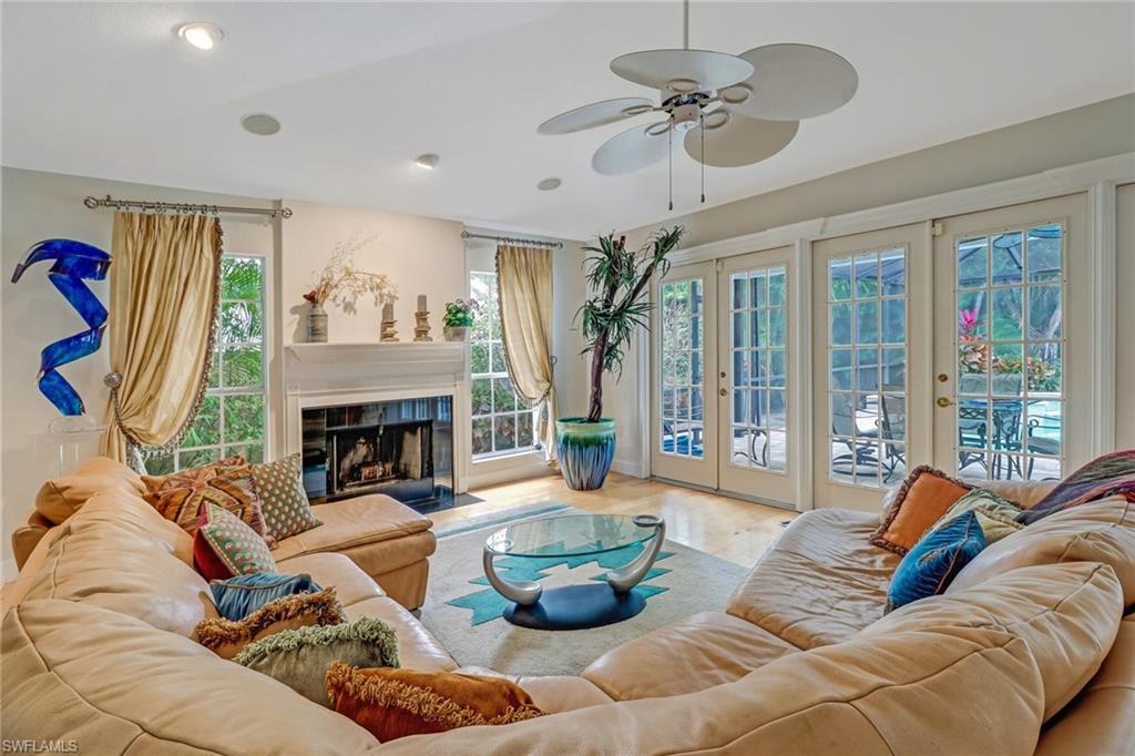 6917 Mill Run Road Naples, FL 34109 - Photo 5 of 29 a living room with furniture and a fireplace