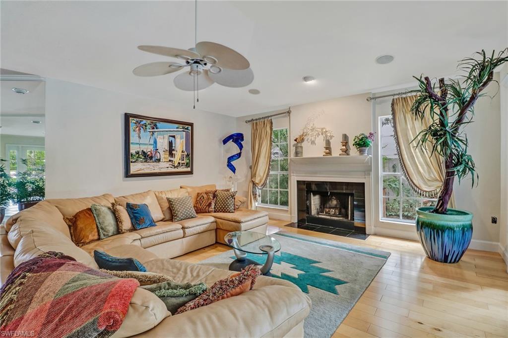 6917 Mill Run Road Naples, FL 34109 - Photo 6 of 29 a living room with furniture and a fireplace