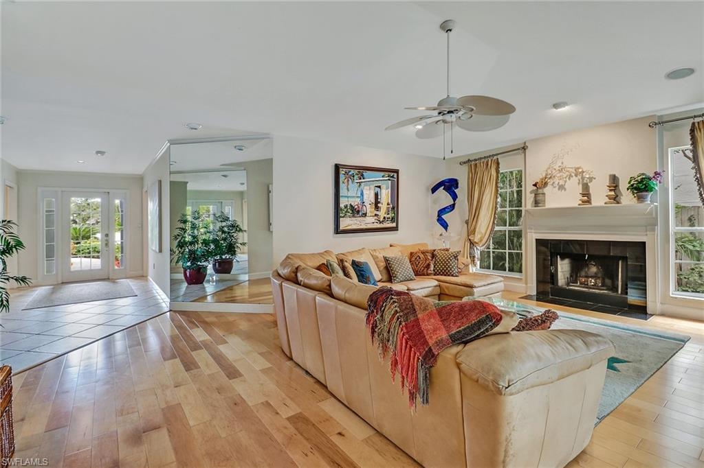 6917 Mill Run Road Naples, FL 34109 - Photo 7 of 29 a living room with furniture and a fireplace