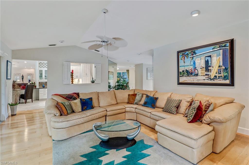 6917 Mill Run Road Naples, FL 34109 - Photo 8 of 29 a living room with furniture and a painting
