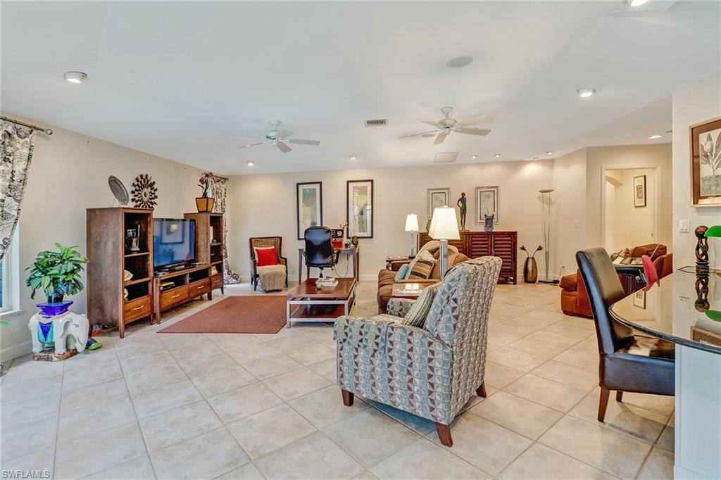 6917 Mill Run Road Naples, FL 34109 - Photo 9 of 29 a living room with furniture and a flat screen tv