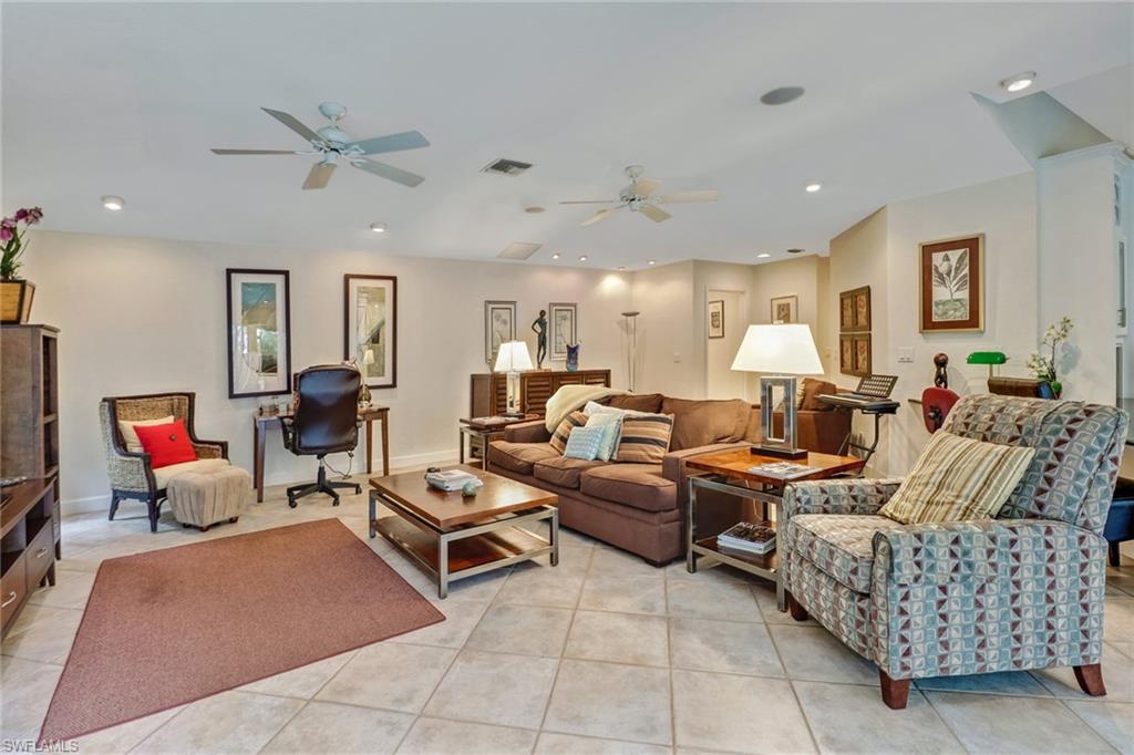 6917 Mill Run Road Naples, FL 34109 - Photo 10 of 29 a living room with furniture and a couch
