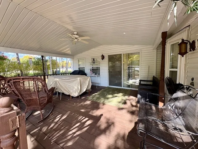 a bedroom with furniture a ceiling fan and a rug