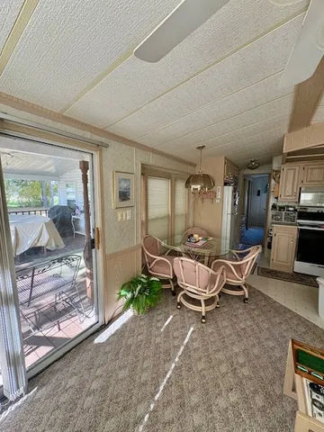 a living room with patio furniture and a floor to ceiling window