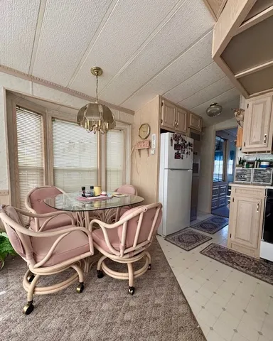 a view of a kitchen with kitchen island dining table and stainless steel appliances