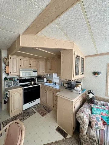 a kitchen with a sink stove and cabinets