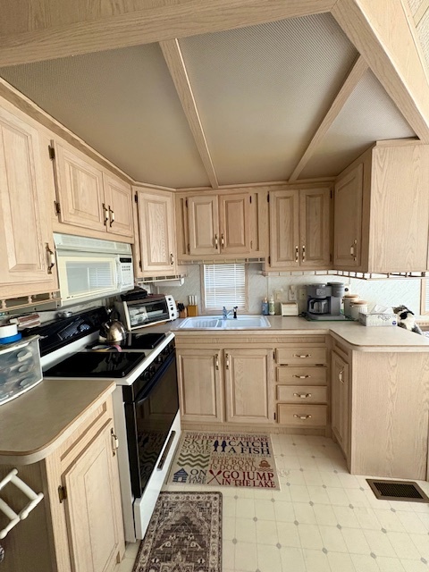 4-3&4 Woodhaven Sublette, IL 61367 - Photo 28 of 33 a kitchen with granite countertop a sink stove a refrigerator and cabinets