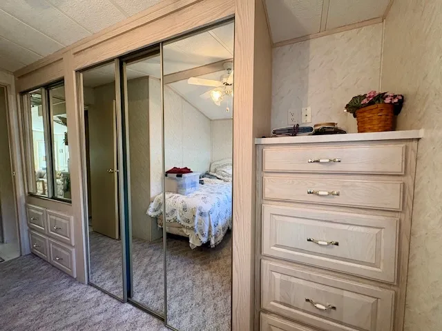 a bed room with a bed and a mirror