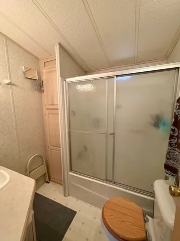 a bathroom with a toilet and shower