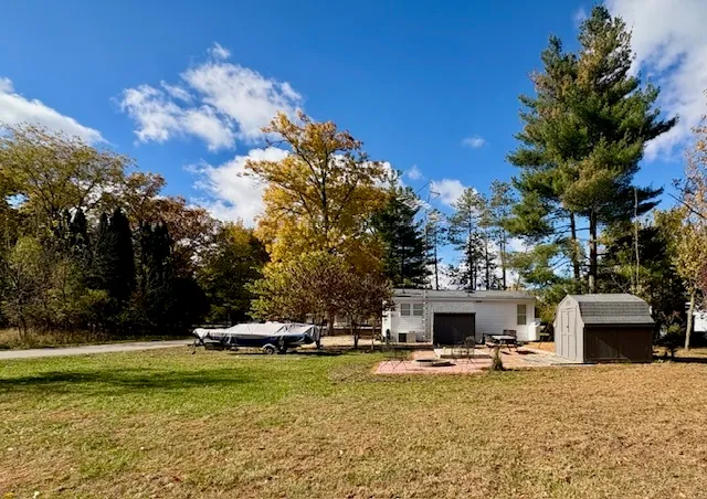 a view of a house with swimming pool and a garden