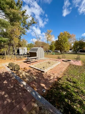 a view of a yard with yellow house