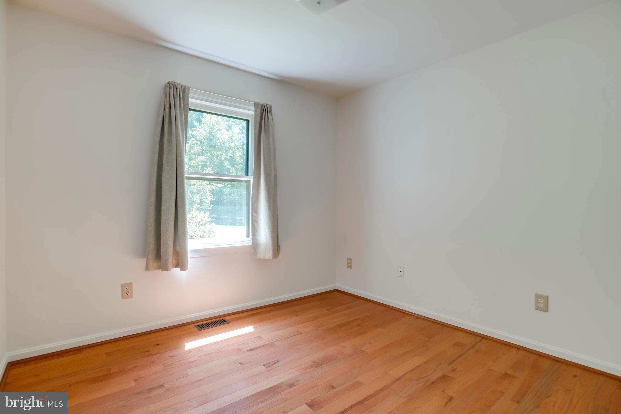 803 Weaver Hollow Road Banco, VA 22711 - Photo 9 of 67 an empty room with wooden floor and windows