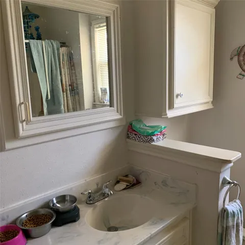 a bathroom with a sink and a window