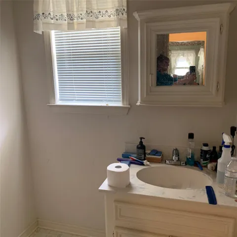 a kitchen with cabinets and window