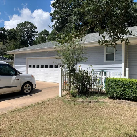 a view of a car parked front of a house