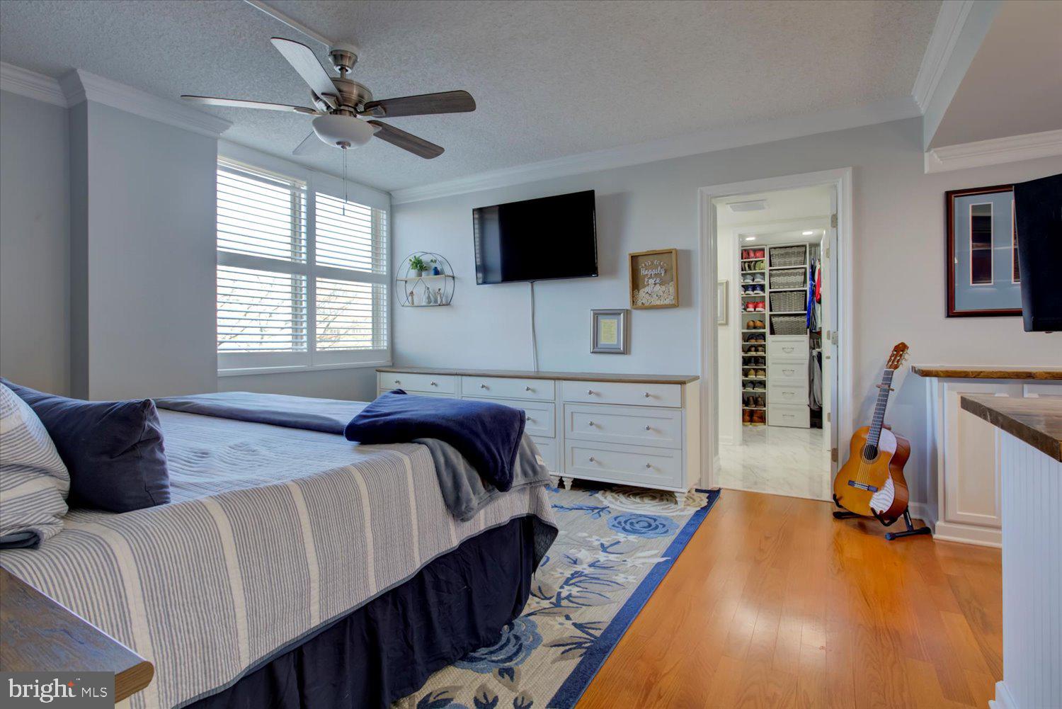 1515 South Arlington Ridge Road, Unit 305 Arlington, VA 22202 - Photo 15 of 41 a bedroom with a bed a flat screen tv and a couch